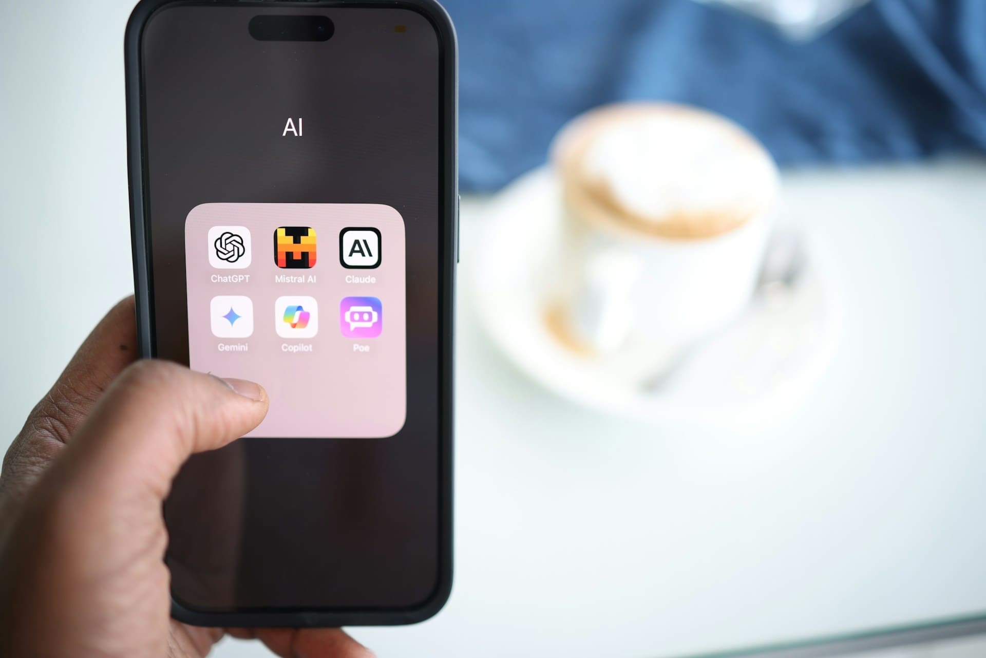 Close-up of a smartphone screen showing popular AI apps like ChatGPT, Mistral, and Claude, illustrating accessible AI tools for nonprofits.